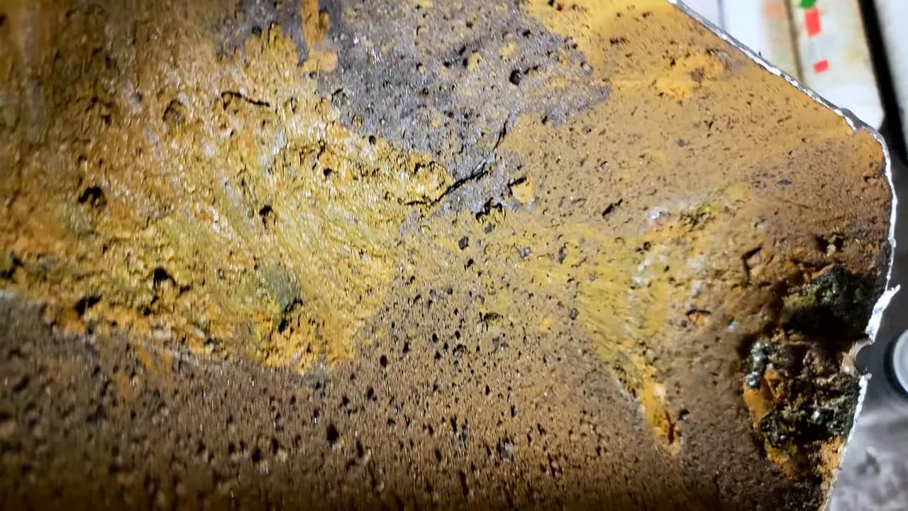 Close-up of the corroded inner surface of a cut open compressor tank
