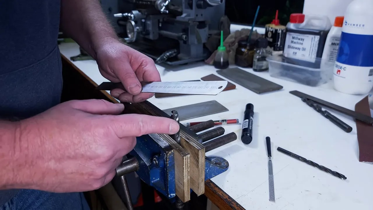 Aligning the cutting lip of a twist drill bit in a vice before sharpening