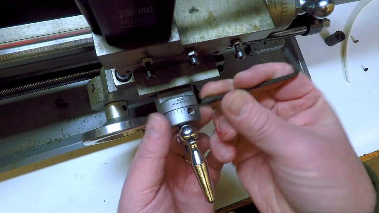 Allen key adjusting mini lathe friction dial while re-positioning the collar