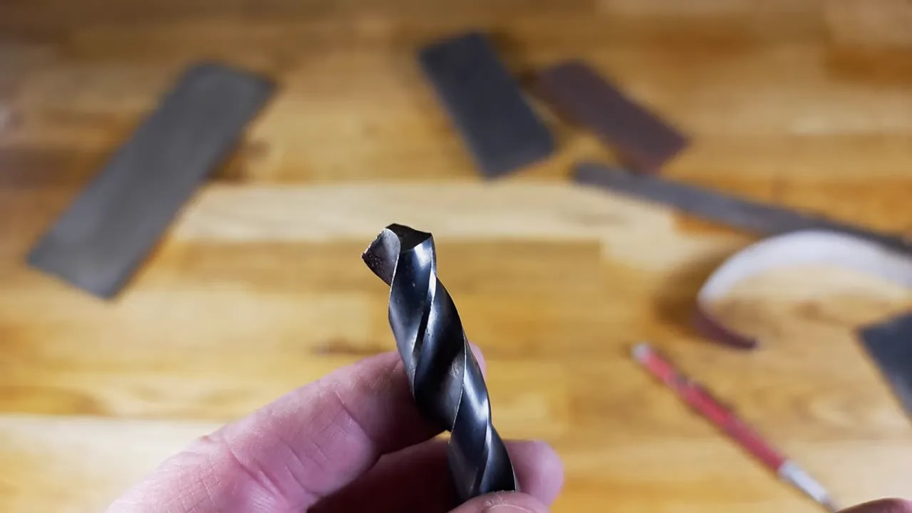Clear close-up of a twist drill bit tip showing the cutting edge and point shape