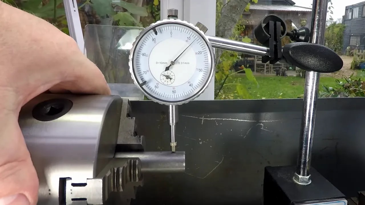 Clear view of dial indicator measuring lathe runout midpoint for tool height