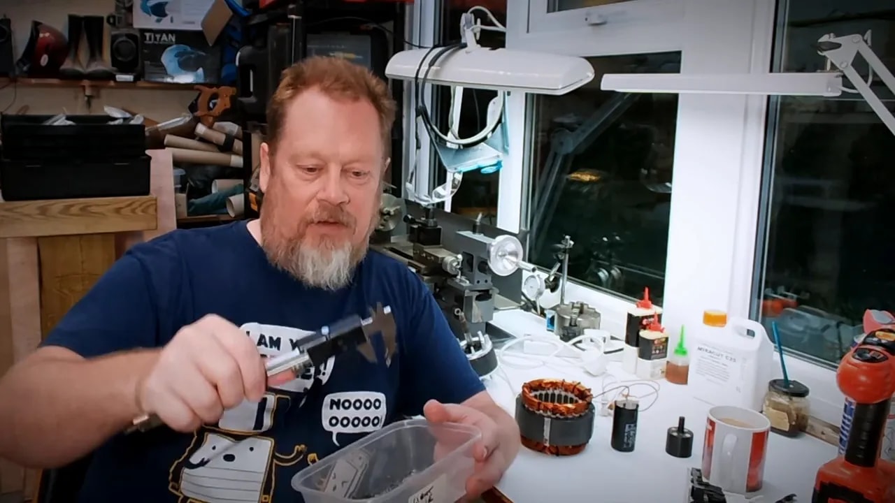 Person handling components for a DIY tool demagnetizer beside the motor stator