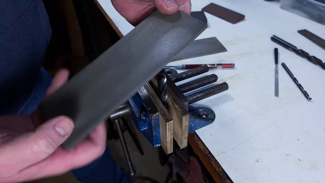 Hand sharpening setup with a Sharpie marking the end of a drill bit in a vice