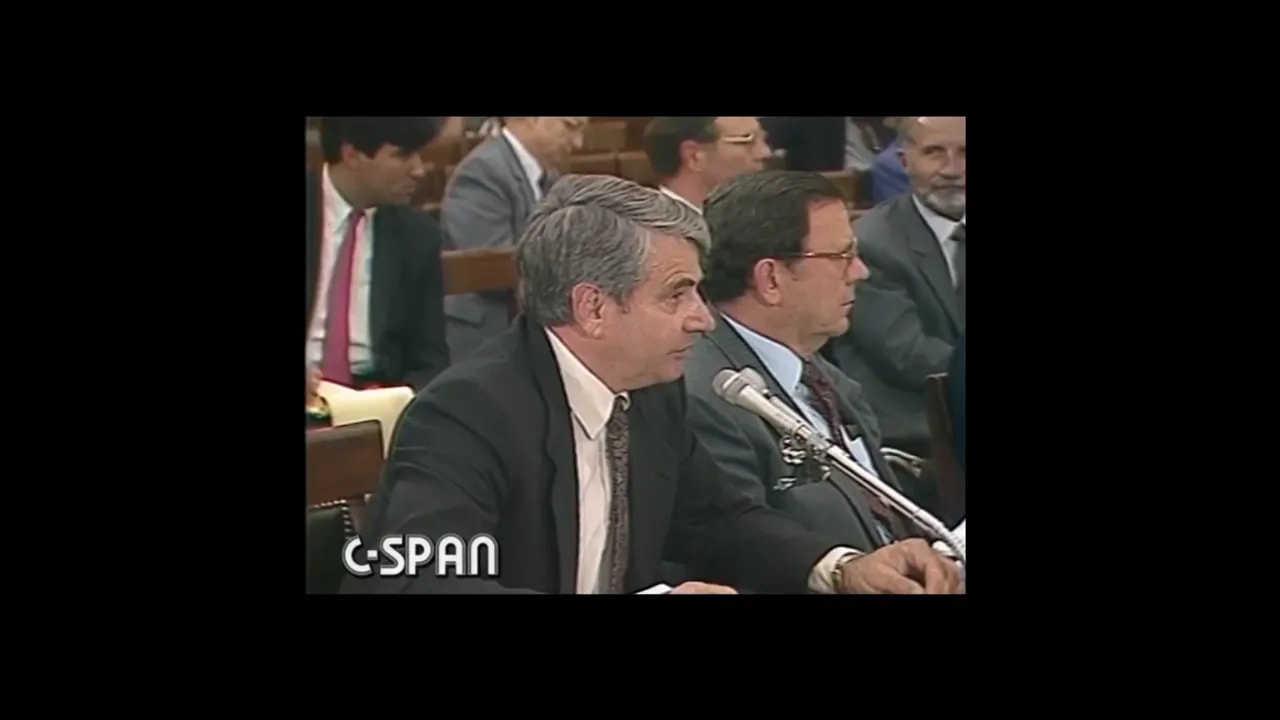 C-SPAN hearing frame with speaker at microphone and text reading US Congressional Hearing 1986