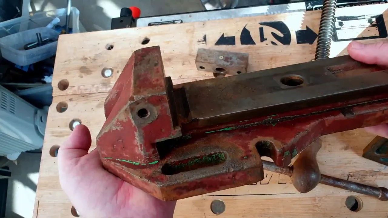 Milling vice body cleaned with most paint removed and red primer visible