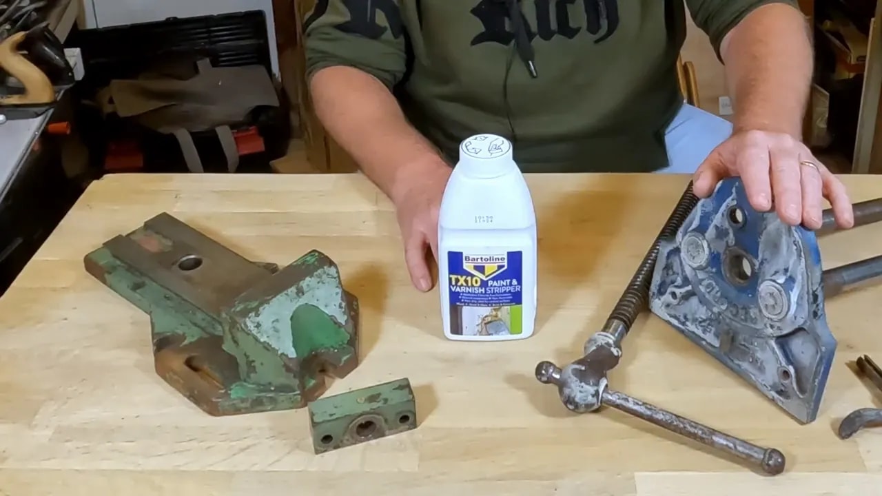 Two old vices and a bottle of TX10 on a workbench