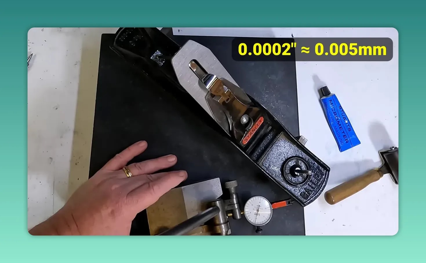 Dial indicator measuring the plane sole on parallels above a granite surface plate