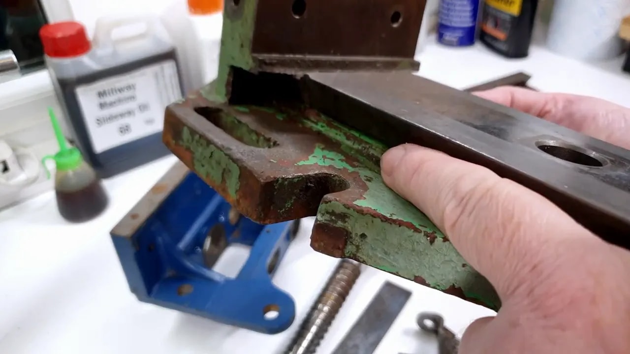 Close view of the milling vice dovetail with dark compacted debris in the lower edge